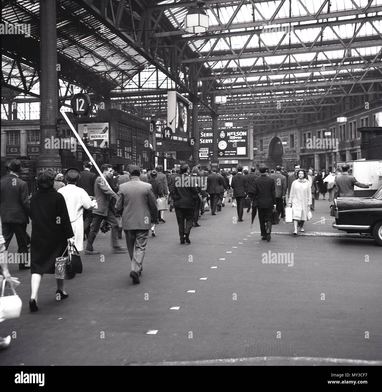 1960s, historical, a view from this era, people walking along the concourse at Waterloo railway station, a busy mainline commuter train station on the southbank in London, England, UK. Stock Photo