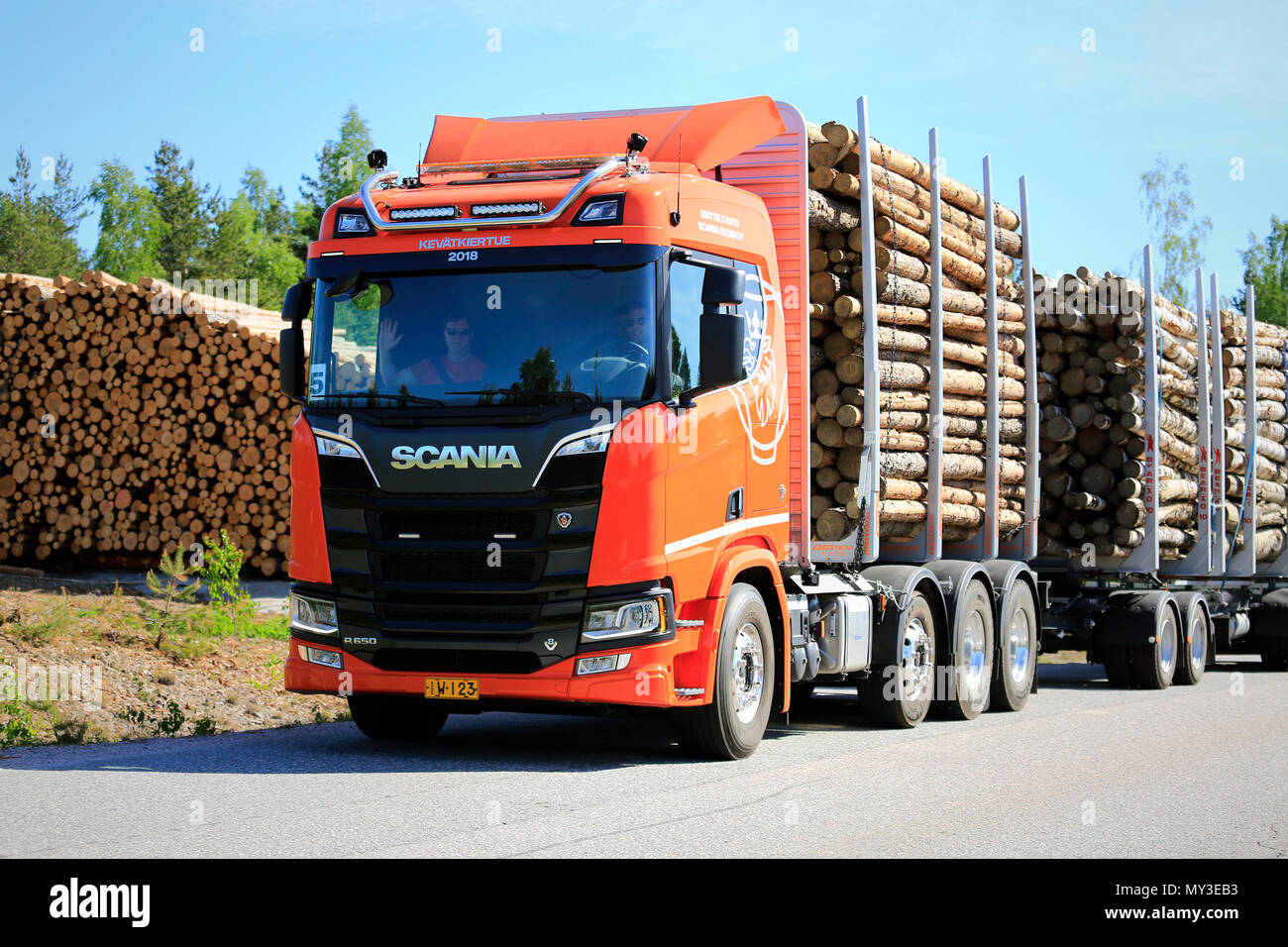 Orange Scania R650 logging truck on test drive on rural road by a logging site during Scania Tour 2018 in Lohja, Finland - May 25, 2018. Stock Photo