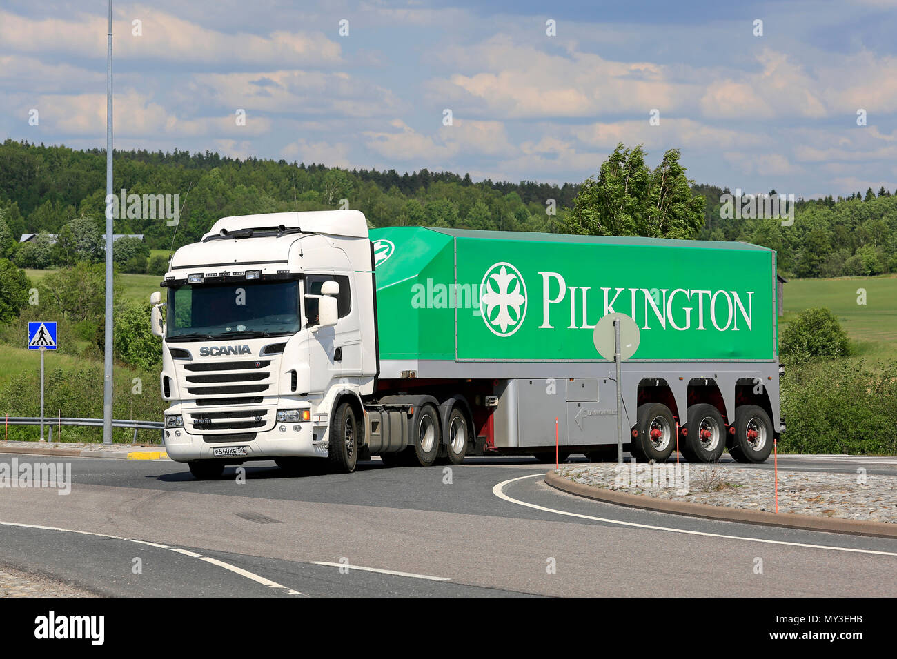 White Scania R560 truck and Pilkinton glass transport trailer on road intersection on a day of summer in Salo, Finland - June 2, 2018. Stock Photo