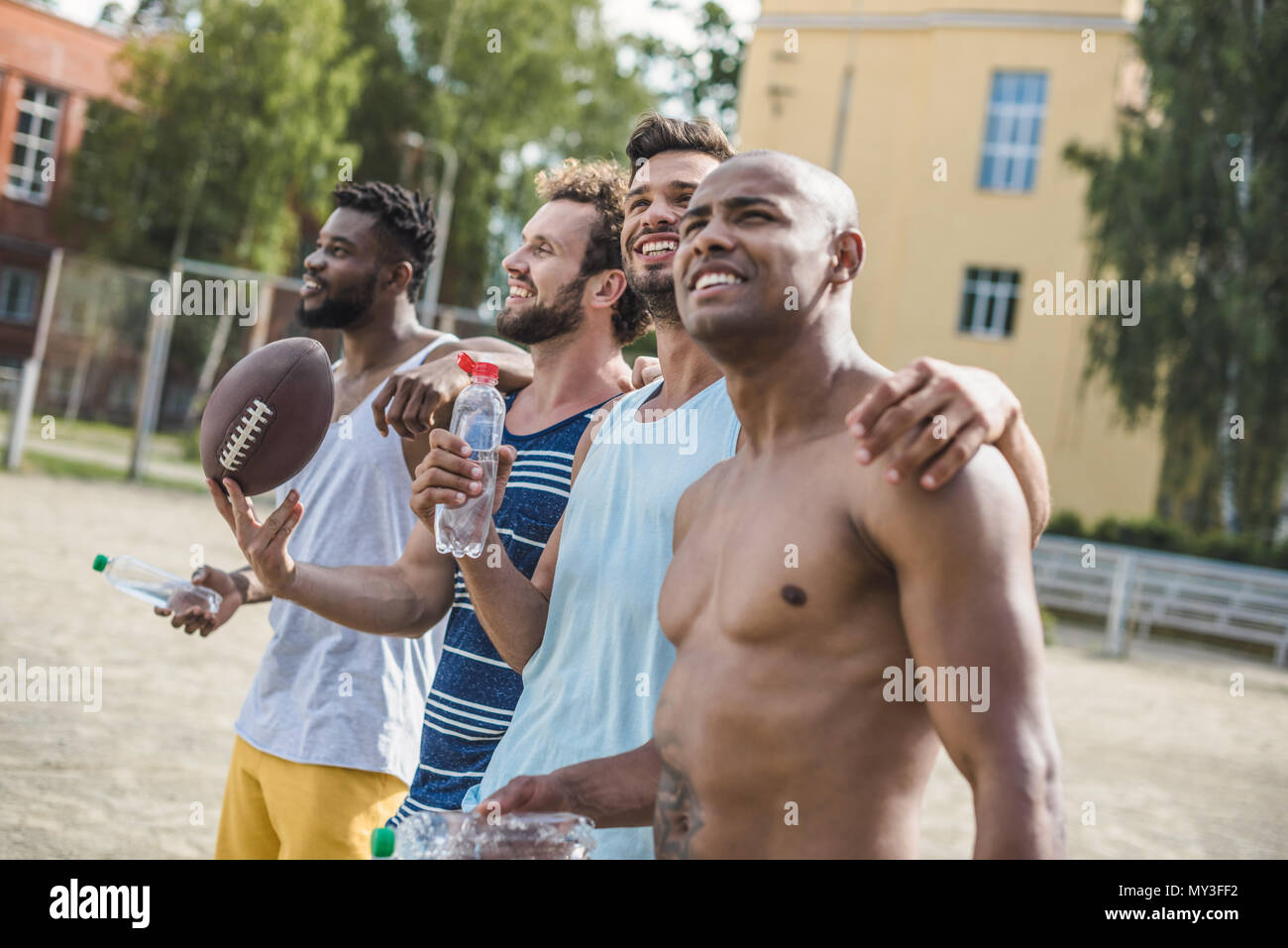 group of young multicultural male football players on court Stock Photo ...