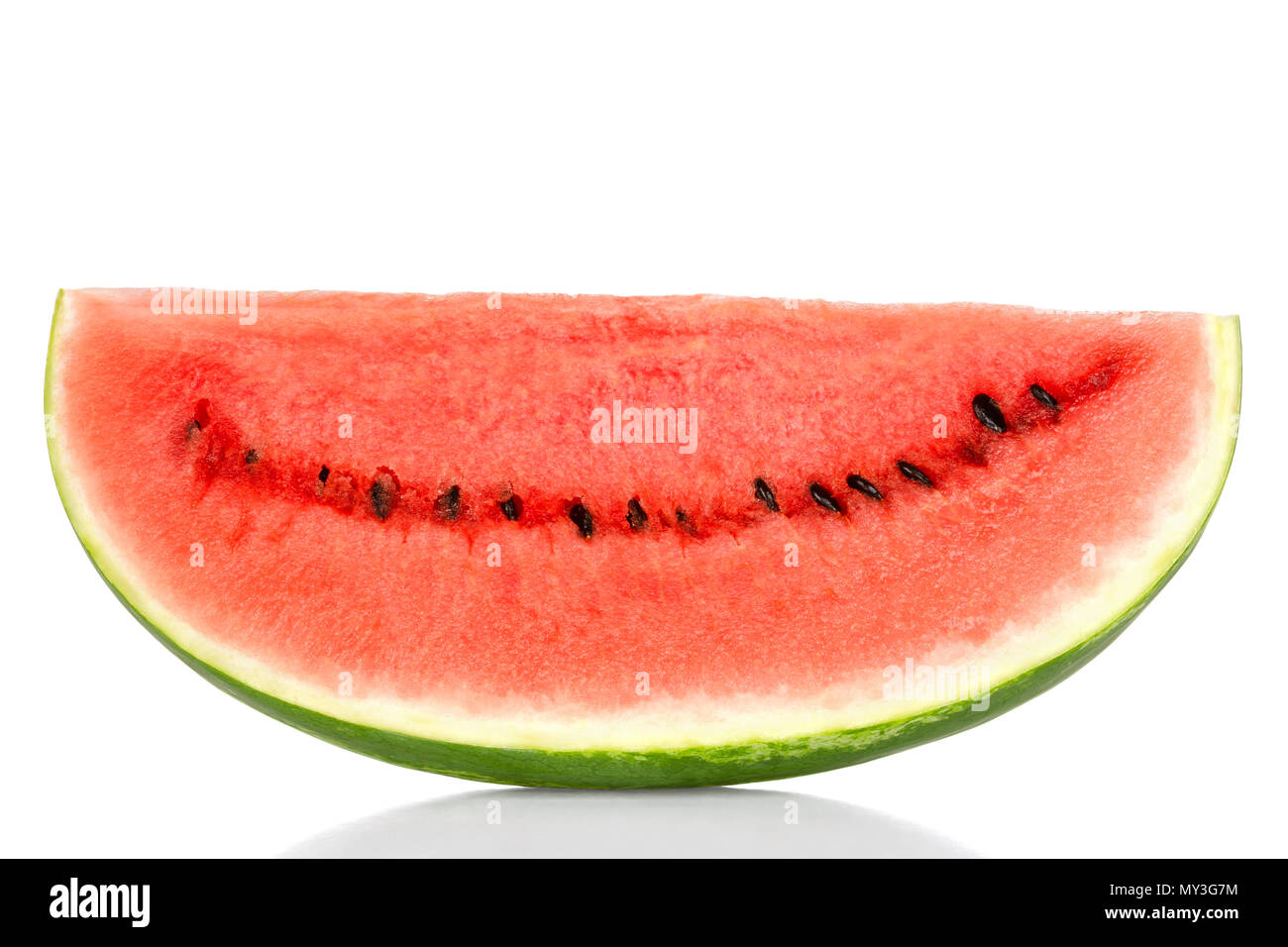 Sweet watermelon slice, front view, over white. Large ripe fruit of Citrullus lanatus with green striped skin, red pulp and black seeds. Edible. Stock Photo