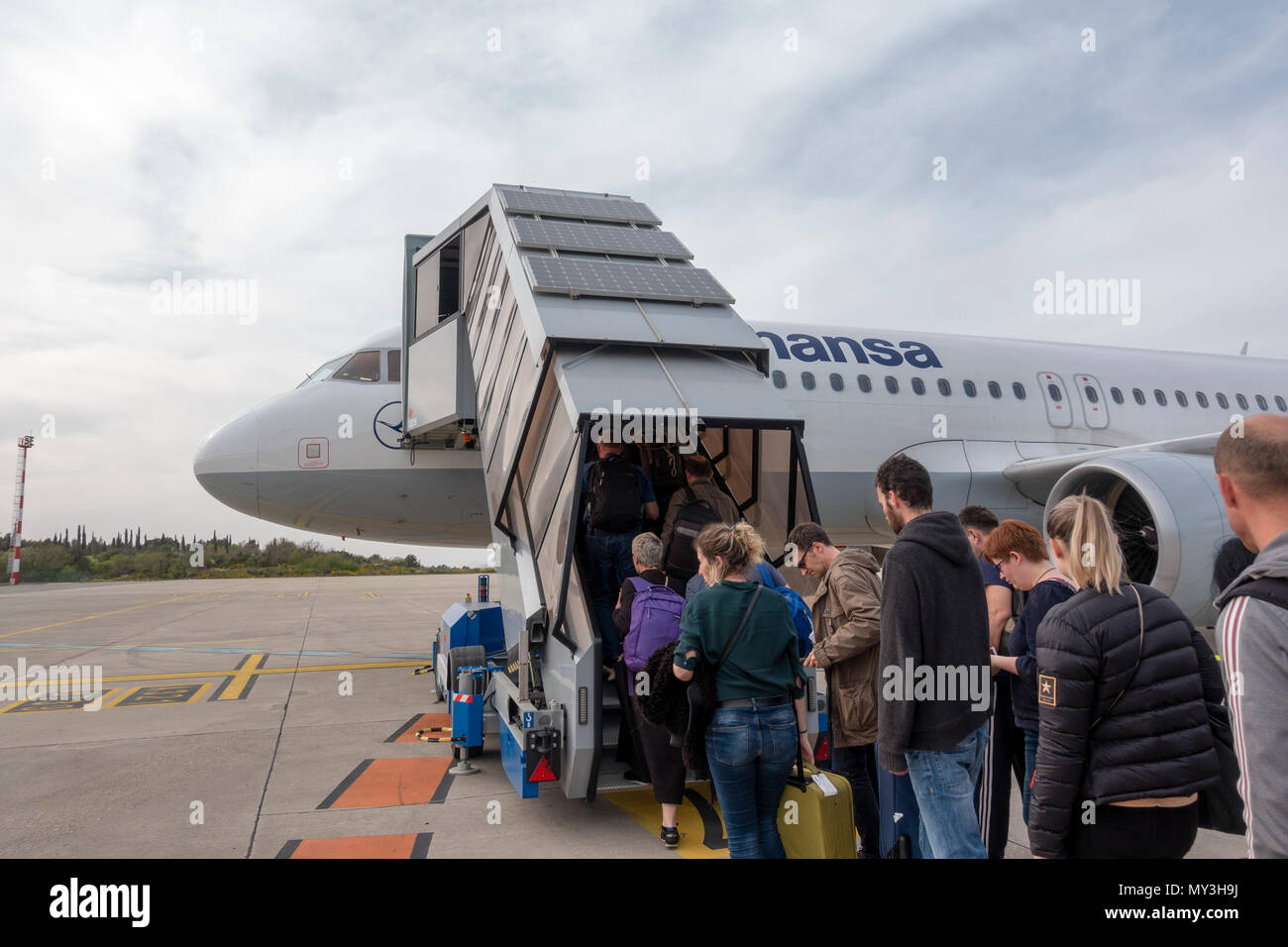 Passengers boarding a Lufthansa Airbus A320-200 via external steps on the airport apron at Dubrovnik Airport, Croatia. Stock Photo