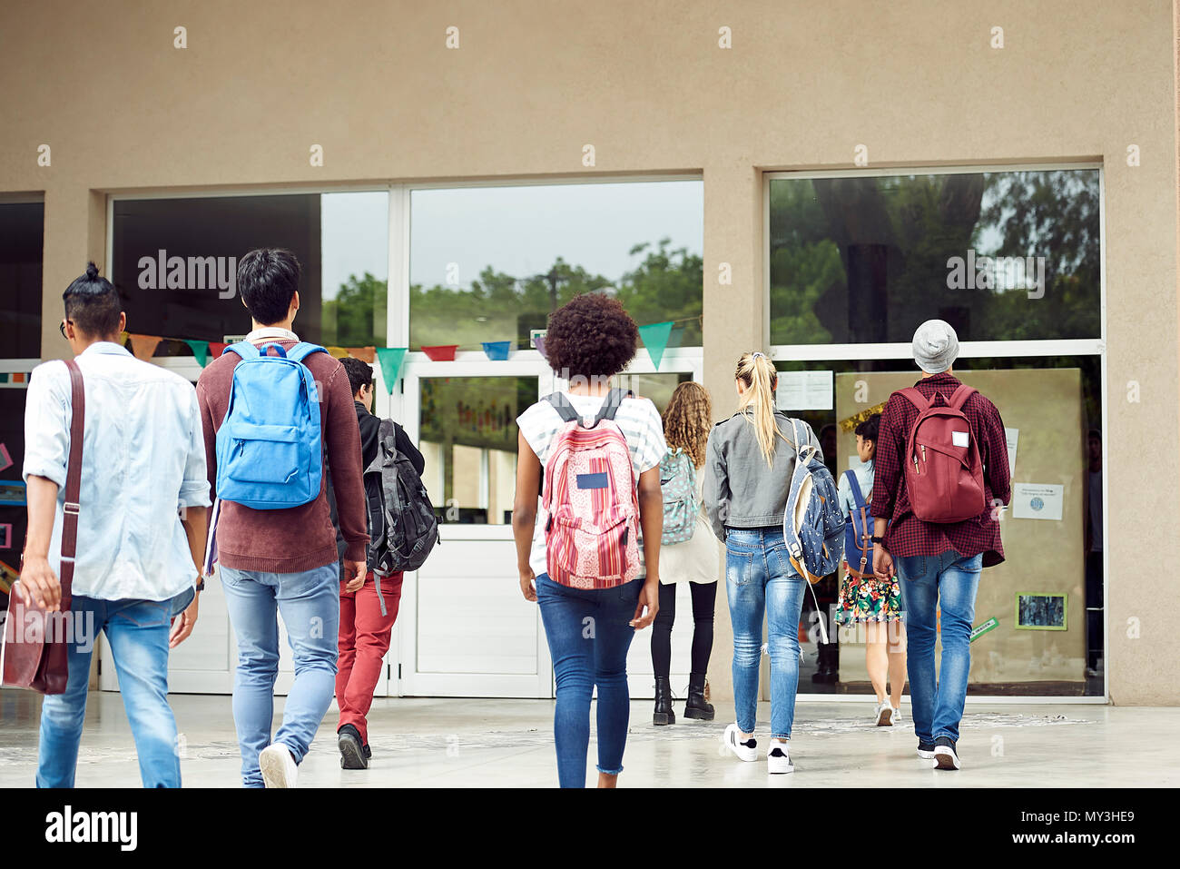 College students walking on campus, rear view Stock Photo