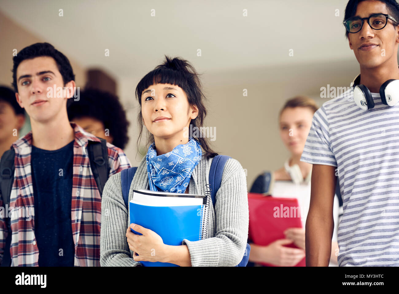 College students walking in corridor Stock Photo