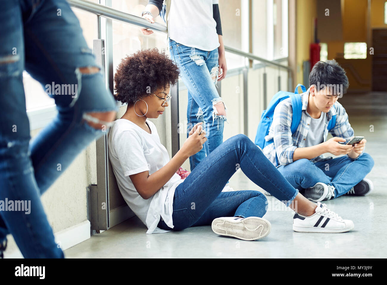Students killing time in corridor between classes Stock Photo