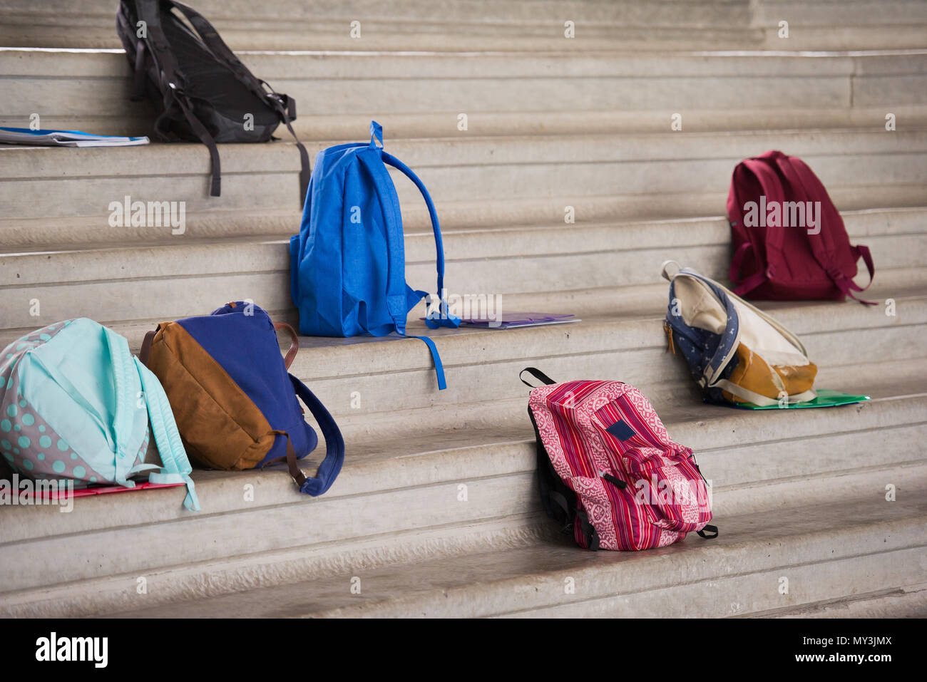 Backpacks left on bleachers Stock Photo