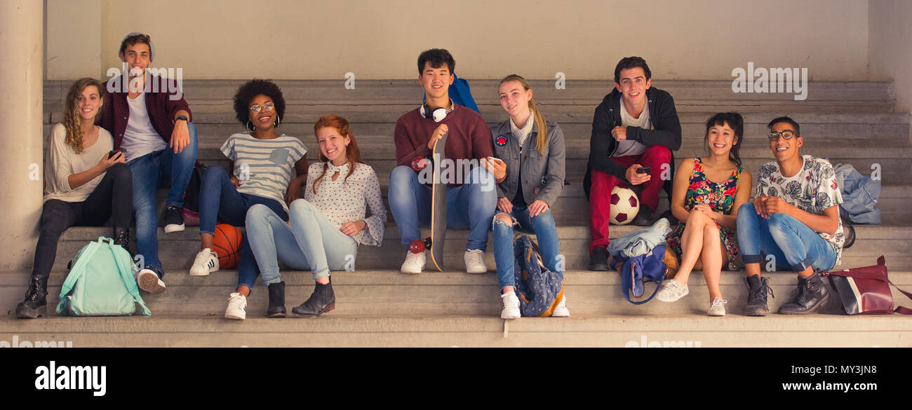 College students relaxing together on bleachers Stock Photo