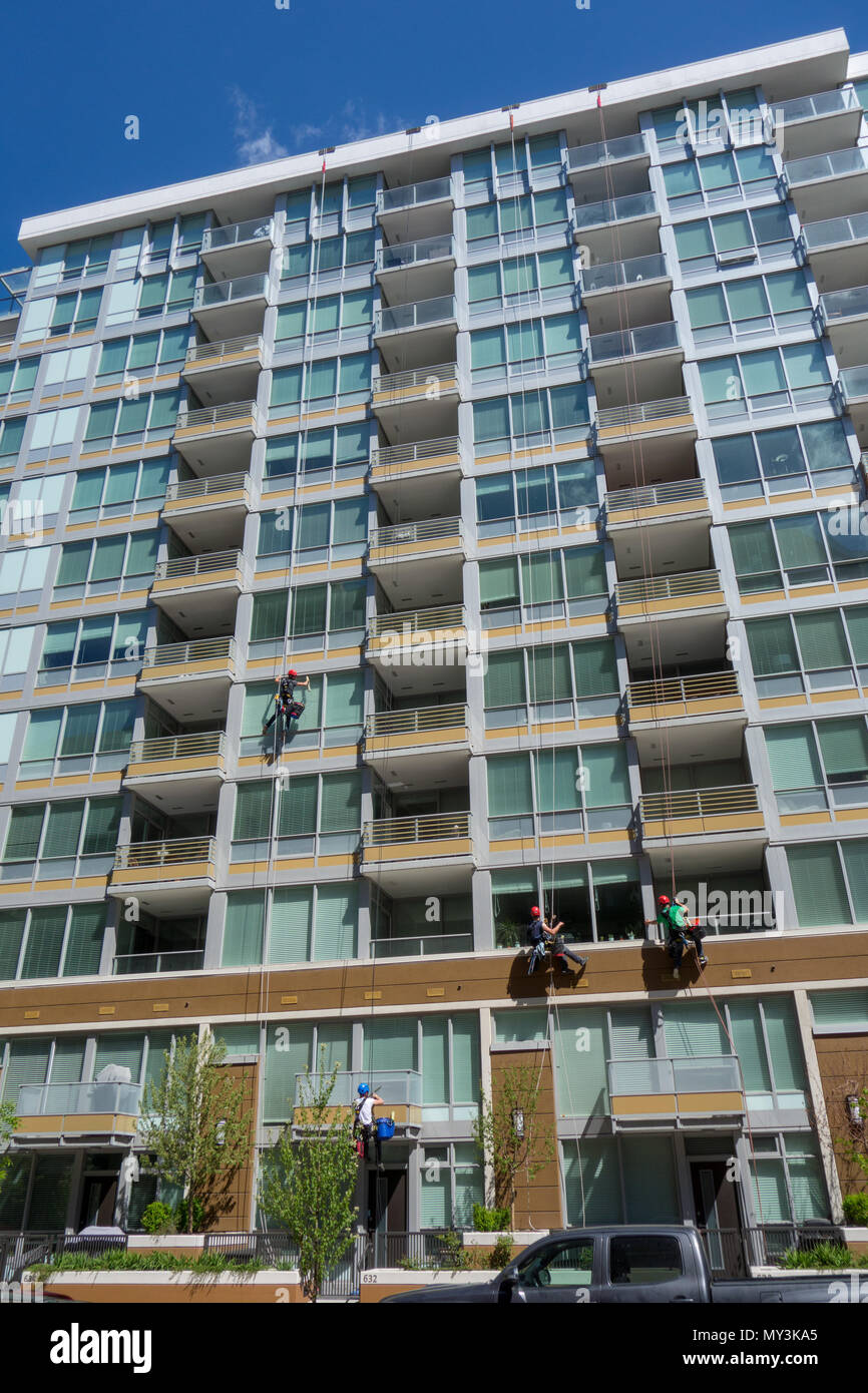 Window washers clean the windows in a high rise residential building