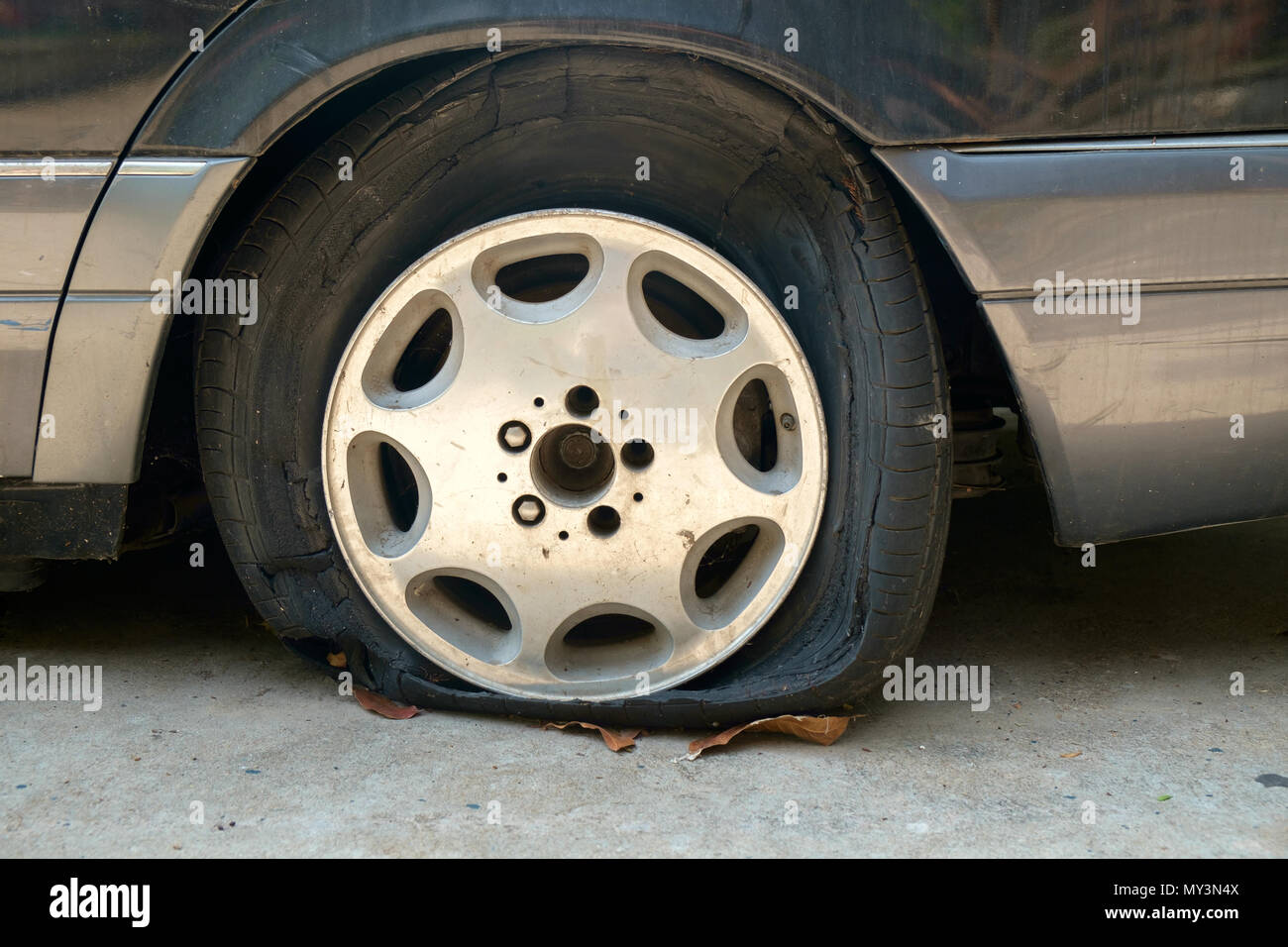 View of flat tires of car was abandoned. Stock Photo