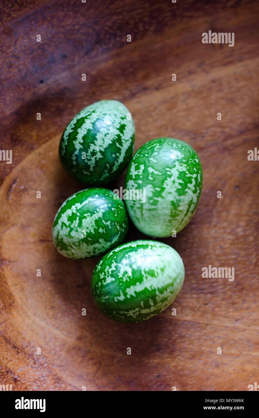 Cucamelons arranged neatly on a table, presenting their unique appearance and freshness, inviting viewers to savor their delicious taste. Stock Photo