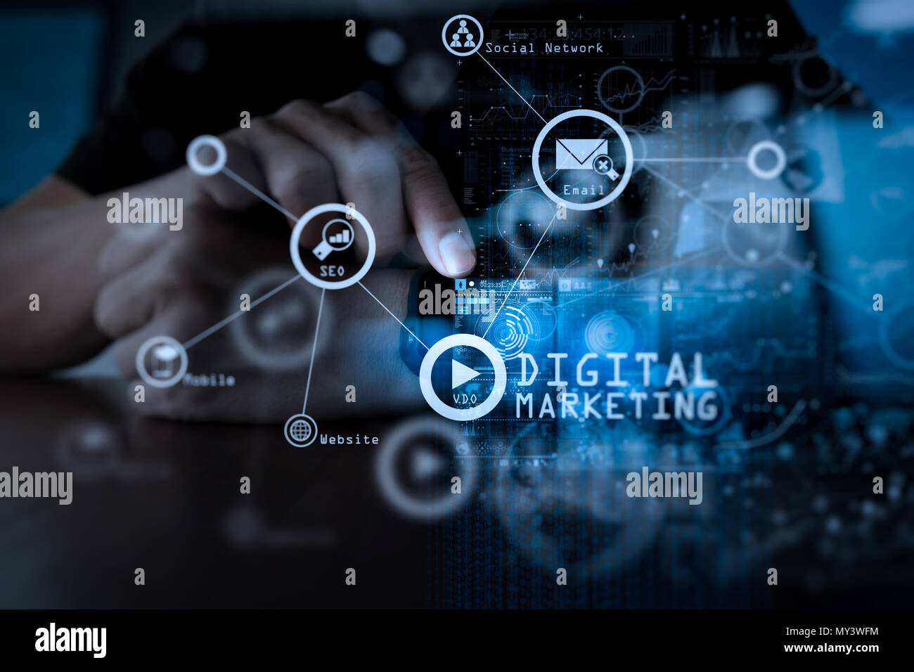 Digital marketing media (website ad, email, social network, SEO, video, mobile app) in virtual screen.Businessman hand using mobile phone with digital Stock Photo