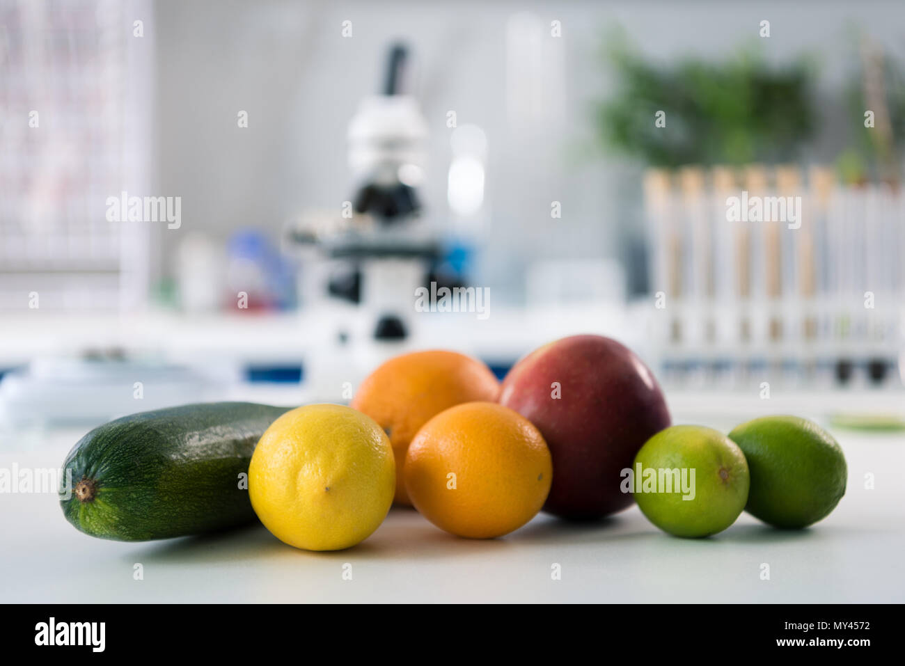 Scientific tools and fruits at workplace in modern biological laboratory Stock Photo