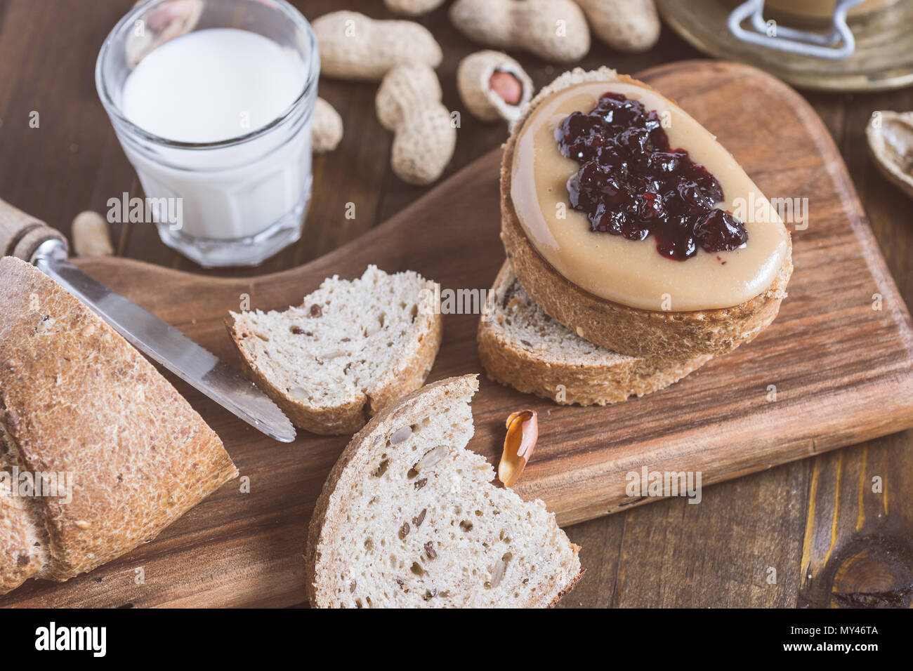 Peanut Butter and Jelly Sandwich on Rustic Wooden Cutting Board Stock