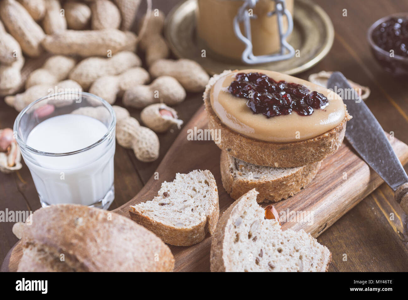 Peanut Butter and Jelly Sandwich on Rustic Wooden Cutting Board Stock Photo