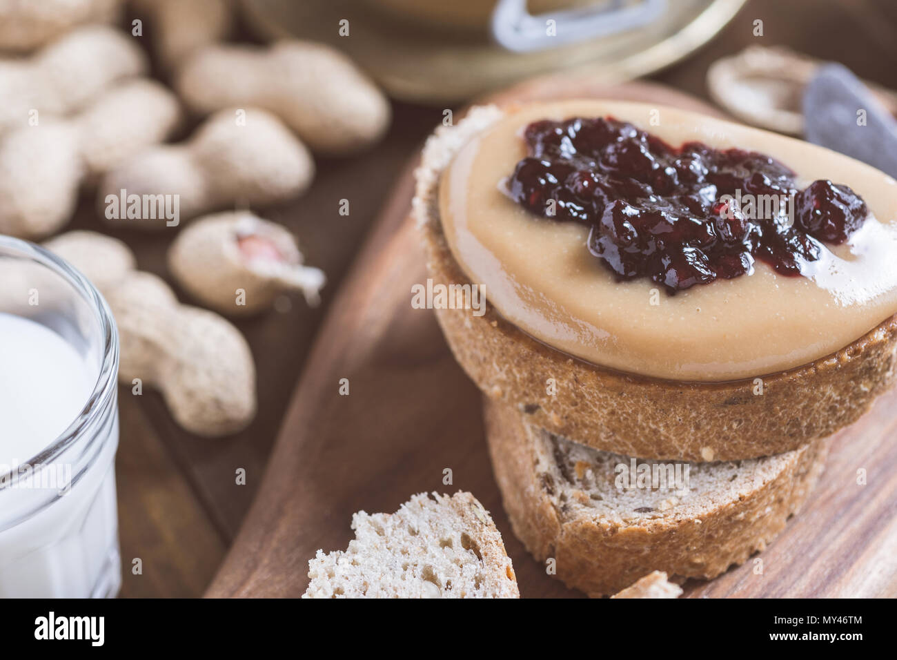 Peanut Butter and Jelly Sandwich on Rustic Wooden Cutting Board Stock