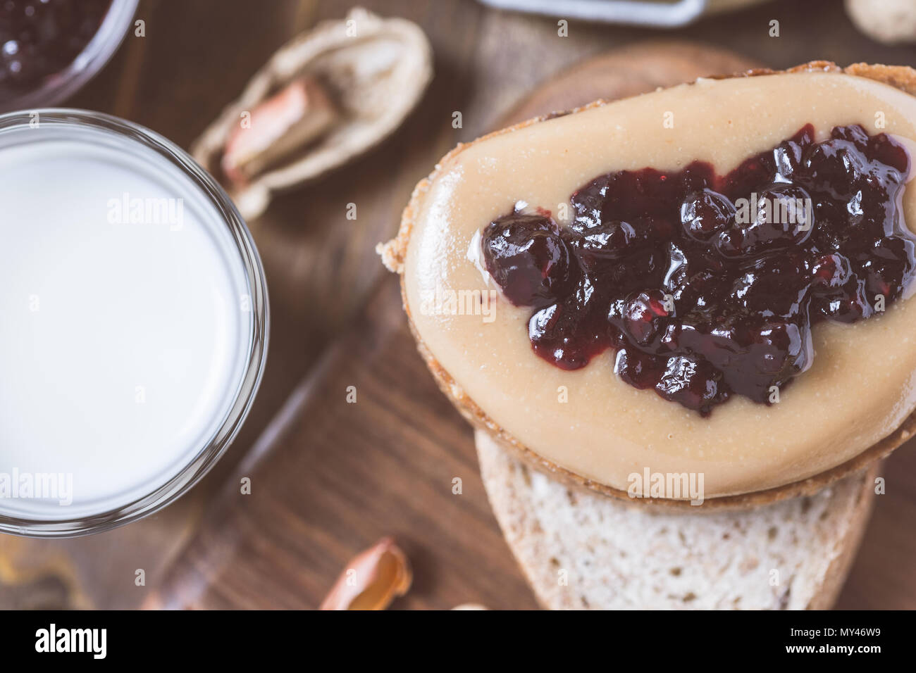 Peanut Butter and Jelly Sandwich on Rustic Wooden Cutting Board Stock