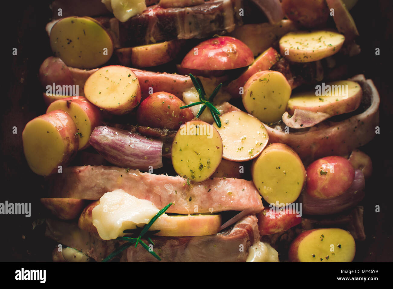 Fresh Lamb Loin Chops with Vegetables in Rustic Clay Dish Prepared for