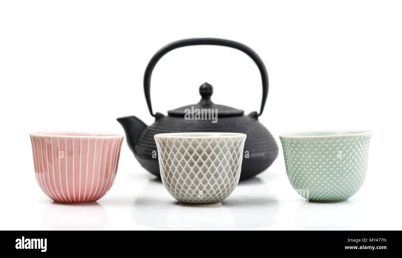 Green tea in cast-iron teapot with small cups isolated on white background Stock Photo