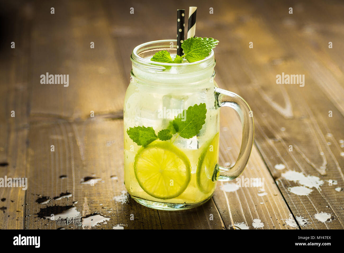 Cold Fresh Lemonade Mojito Cocktail With Ice Lemon And Mint Leaves In Mason Jar On Rustic Dark Wooden Background Summer Concept Stock Photo Alamy