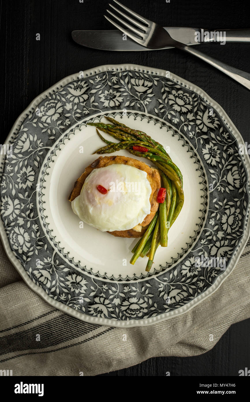 Toasted Bread with Poached Egg, Green Asparagus and Chili Peppers. Healthy Breakfast Concept. Stock Photo