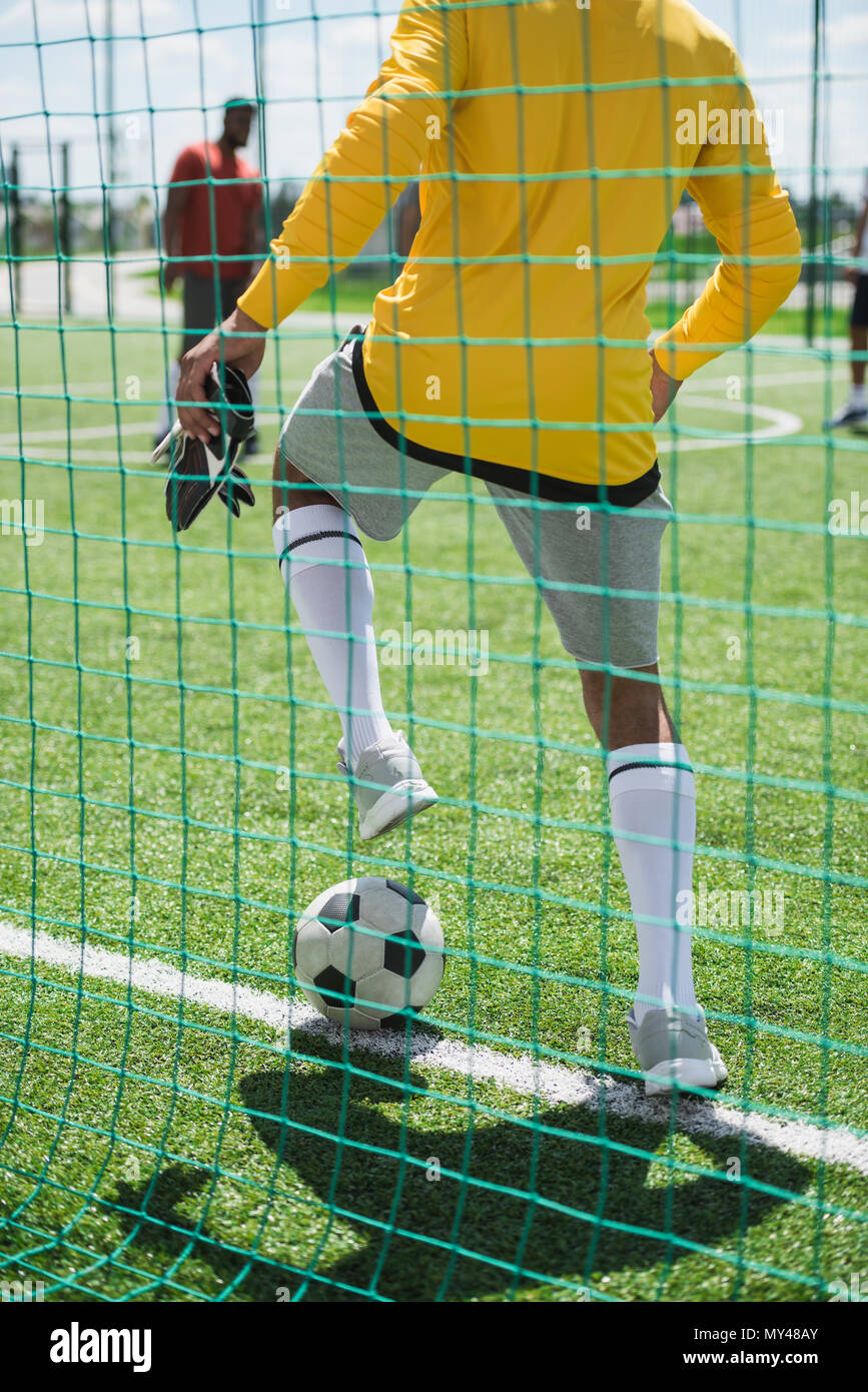 https://c8.alamy.com/comp/MY48AY/partial-view-of-goalkeeper-stopping-ball-during-soccer-match-on-pitch-MY48AY.jpg