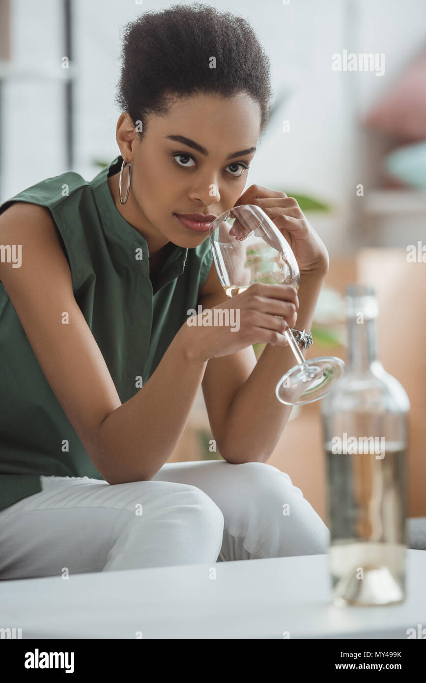 young attractive african american woman drinking white wine from glass Stock Photo
