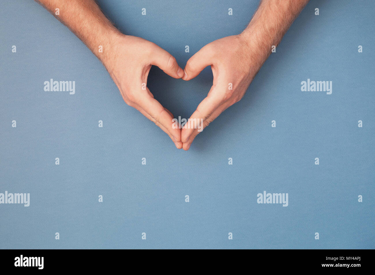 Male hands in shape of heart. Healthcare and chirty concept. Stock Photo