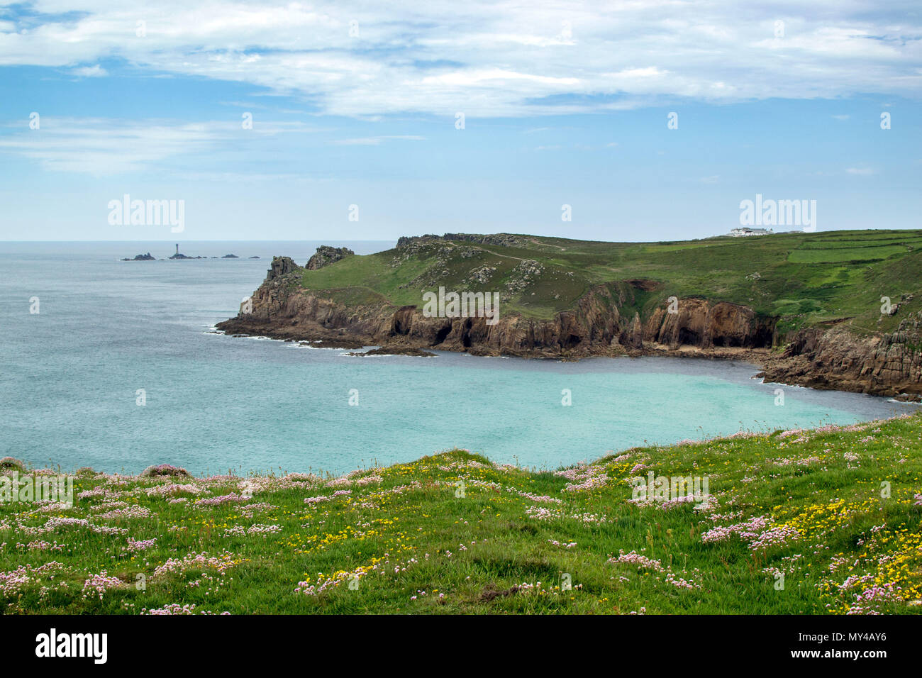 Thrift and Longships Lighthouse, Land's End, Cornwall UK Stock Photo