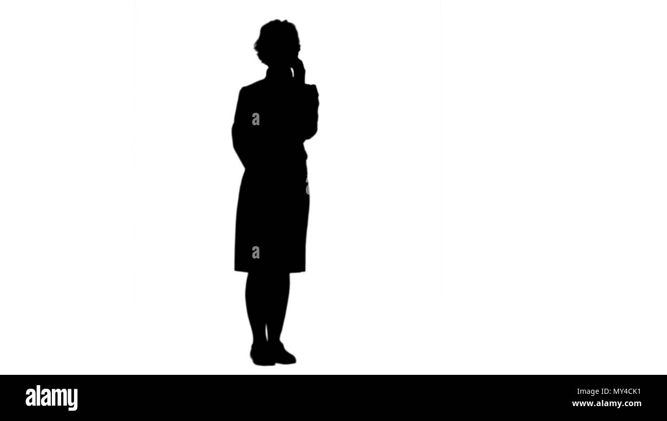 Silhouette Smiling woman having a phone call track matte Stock Photo