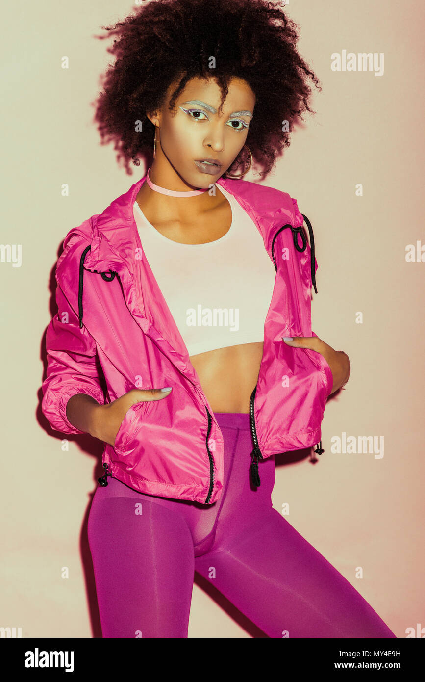 african american 80s girl in pink clothes posing for fashion shoot