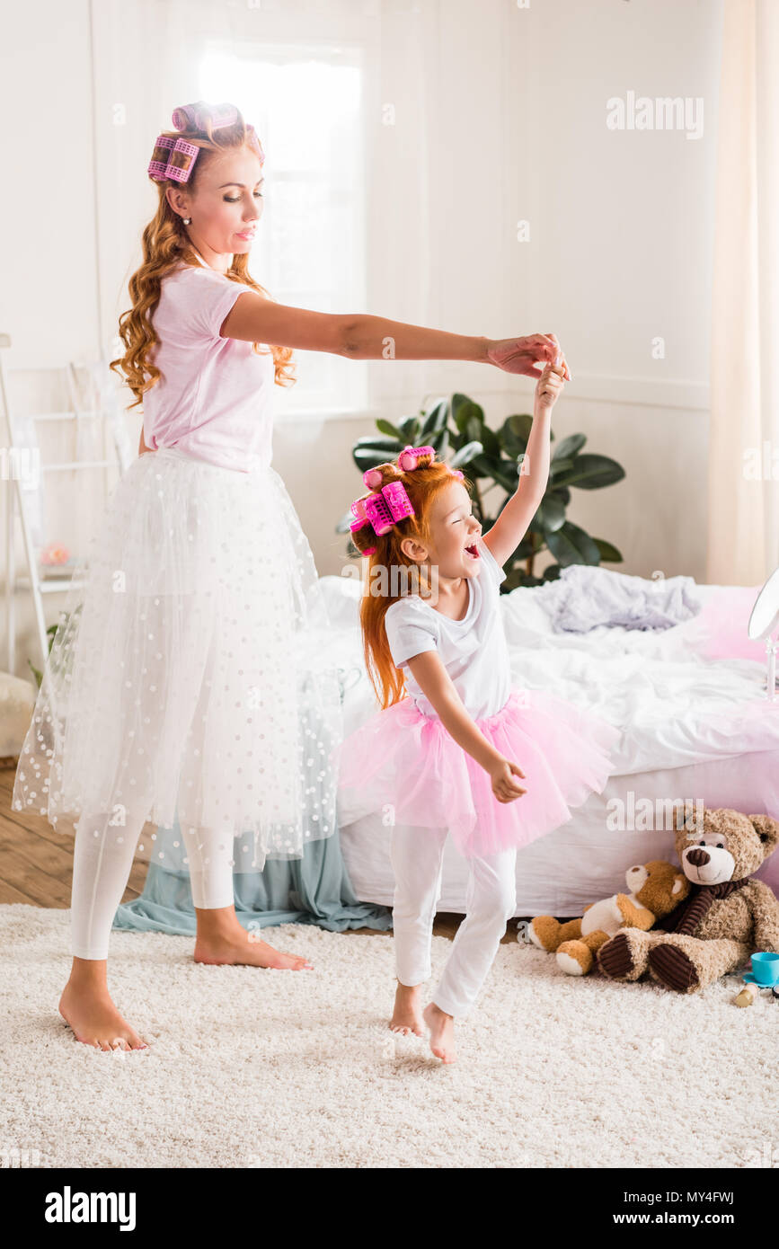 mother and daughter in tutu tulle skirts having fun together at home Stock Photo