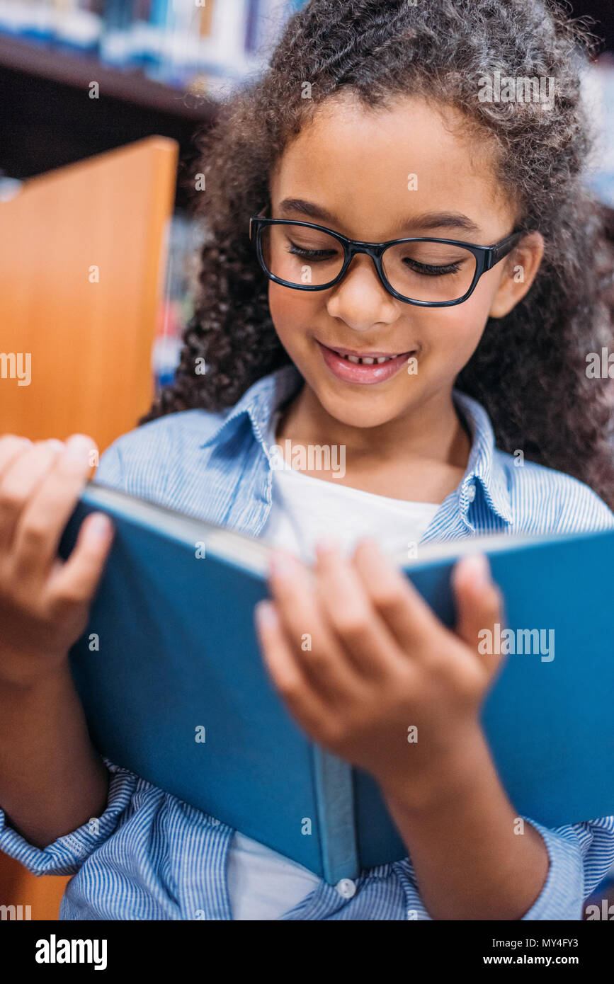 close-up portrait of african american schoolgirl reading book Stock ...