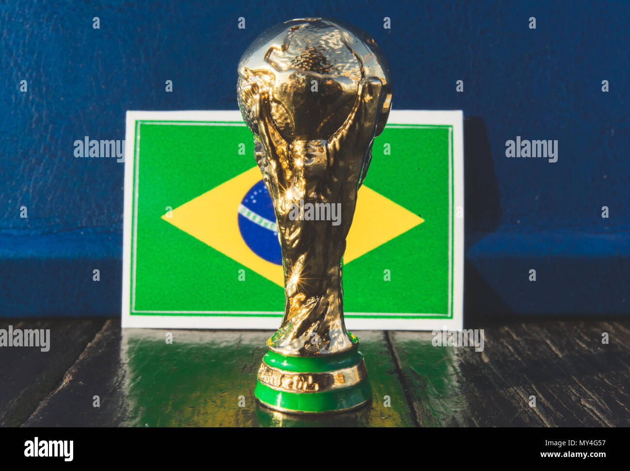 June 6, 2018 Moscow, Russia. FIFA World Cup trophy on the background of the flag of Brazil. Stock Photo