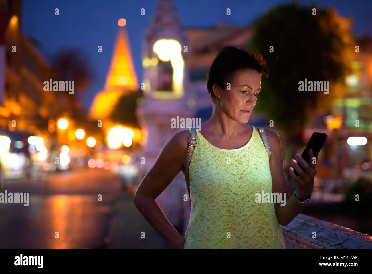 Mature beautiful Scandinavian tourist woman exploring Nakhon Pat Stock Photo