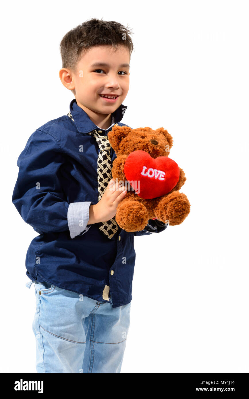 Studio shot of cute happy boy smiling and holding teddy bear wit Stock ...