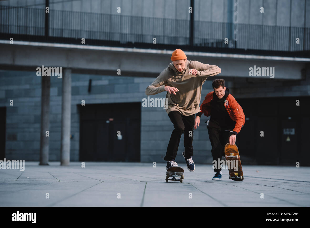 stylish young men in streetwear outfit riding skateboards Stock Photo -  Alamy