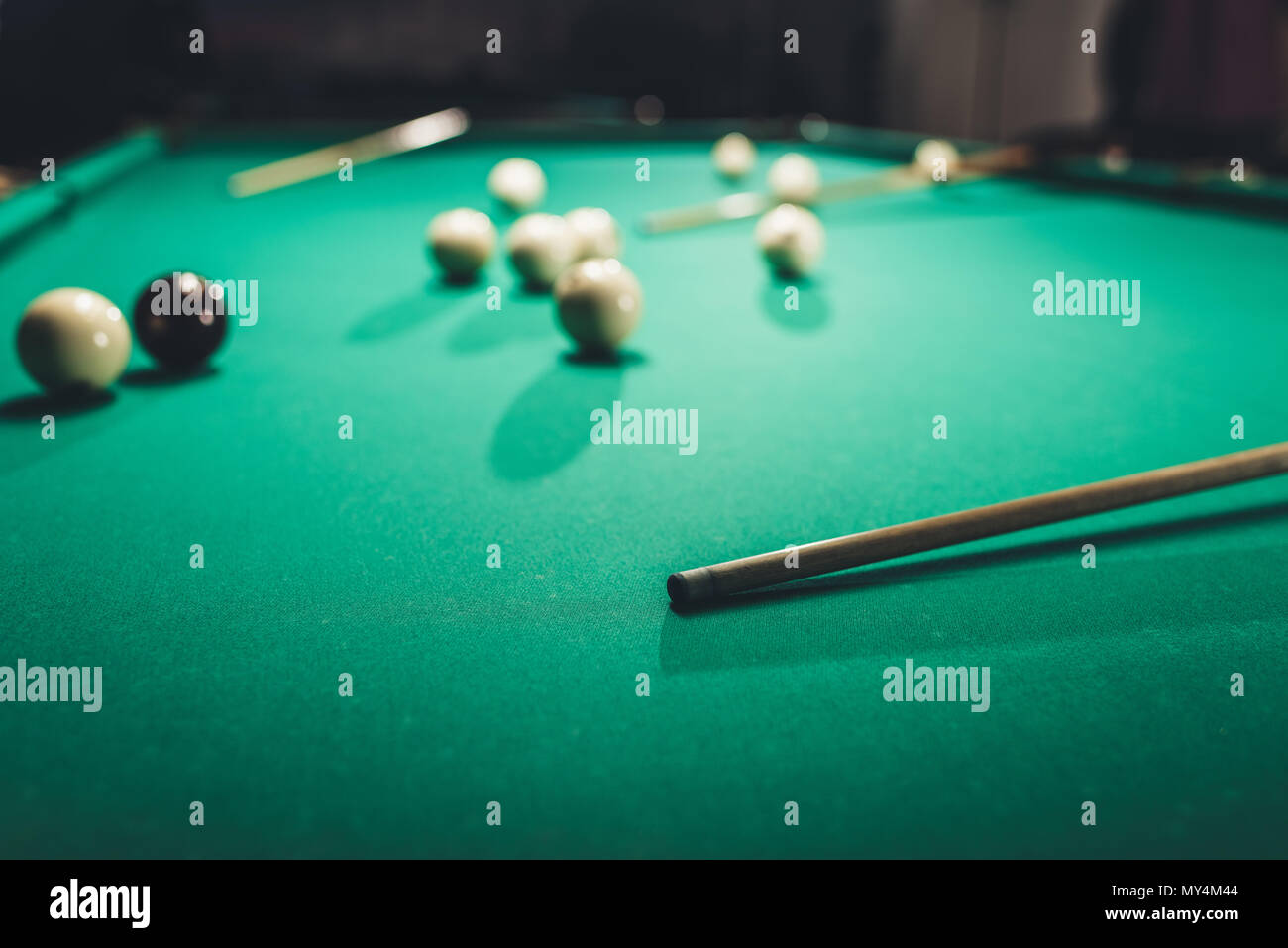 green billiard table with russian pool balls and cues Stock Photo