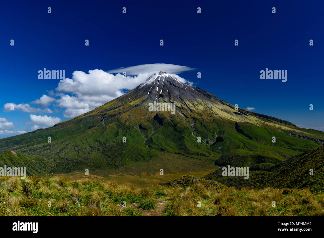 Mount Taranaki with clouds in sunny day, New Plymouth, New Zealand Stock Photo