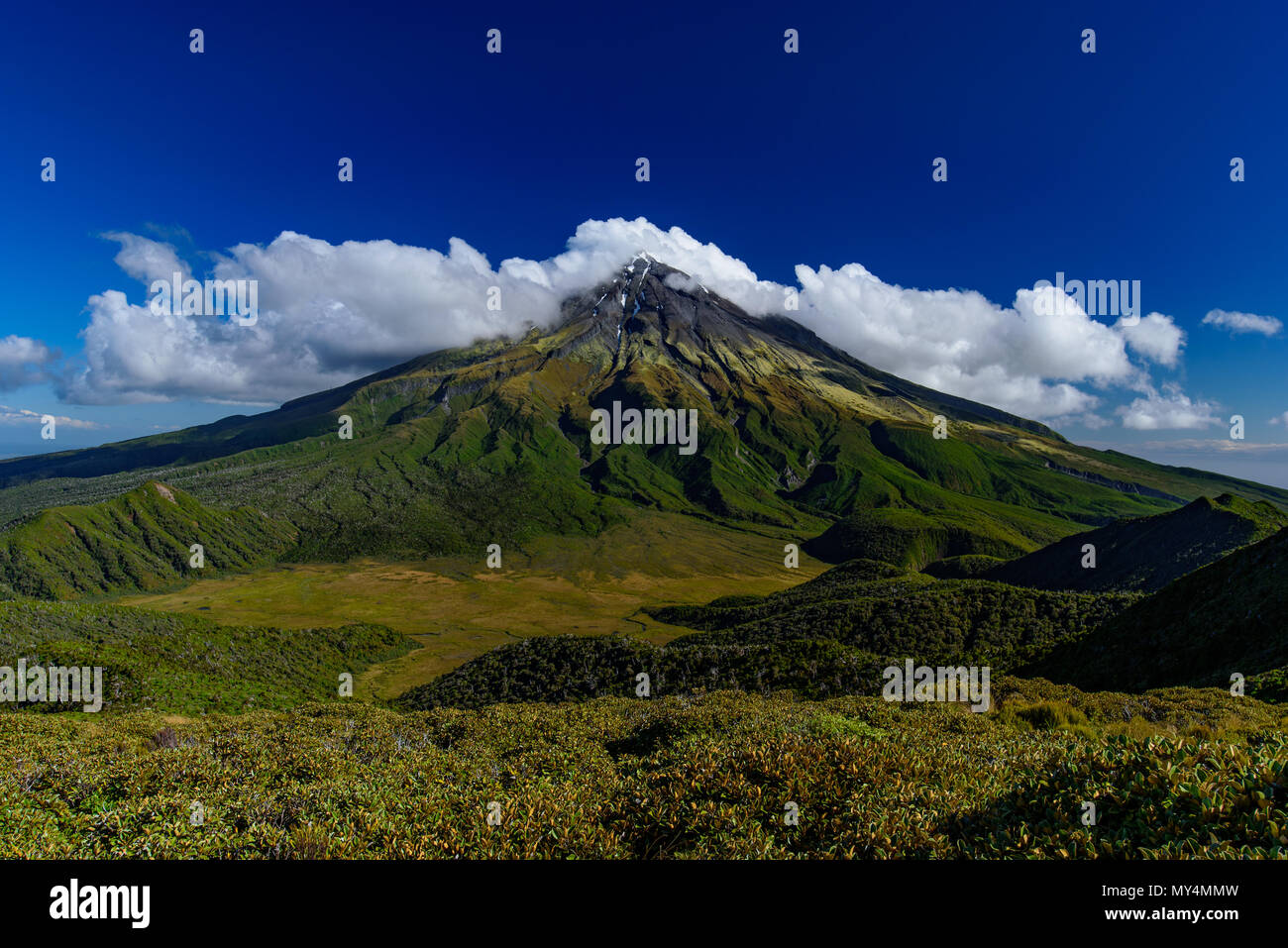 Mount Taranaki with clouds in sunny day, New Plymouth, New Zealand Stock Photo