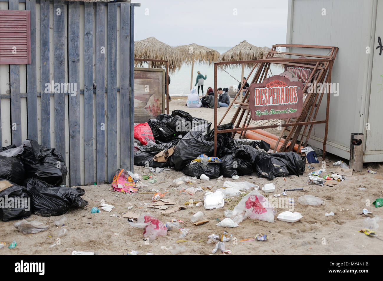 VAMA VECHE, ROMANIA - MAY 1, 2018: Garbage (especially empty bottles), after an all night party, early in the morning just before sunrise Stock Photo