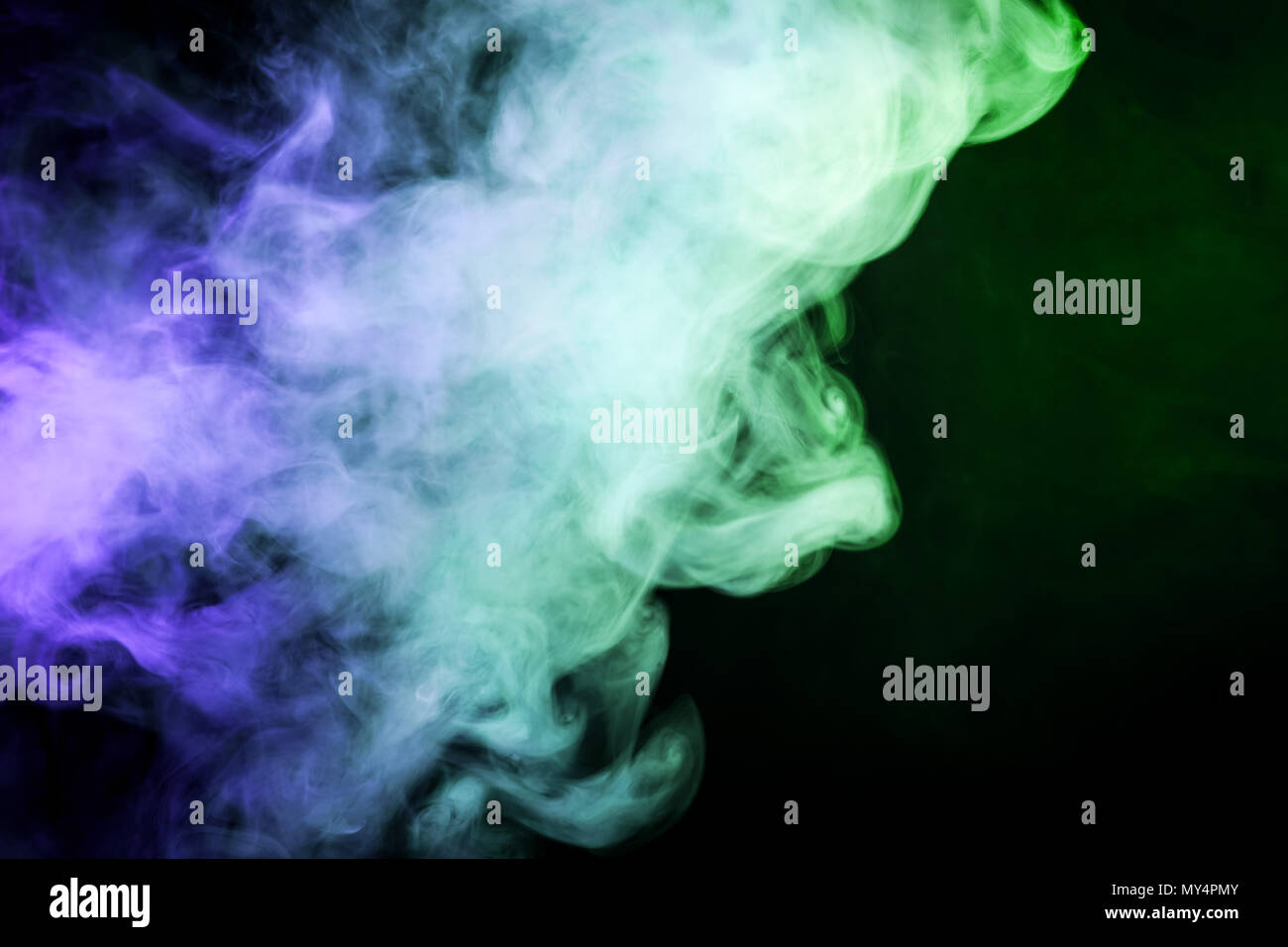 Green and blue smoke on black background Stock Photo - Alamy