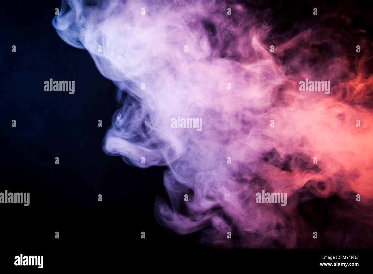 Pink and blue smoke on black background Stock Photo - Alamy