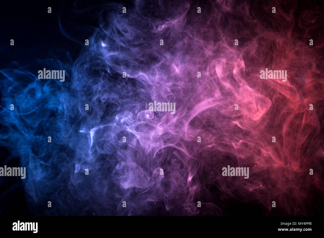 Pink and blue smoke on black background Stock Photo - Alamy