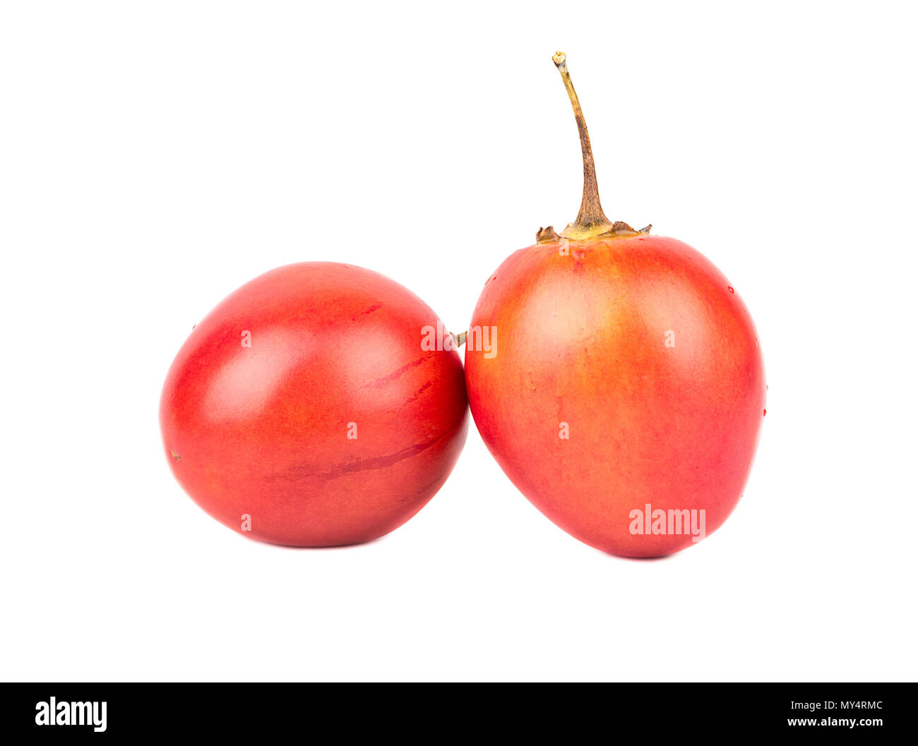 Two fresh exotic fruit tamarillo on white background Stock Photo - Alamy