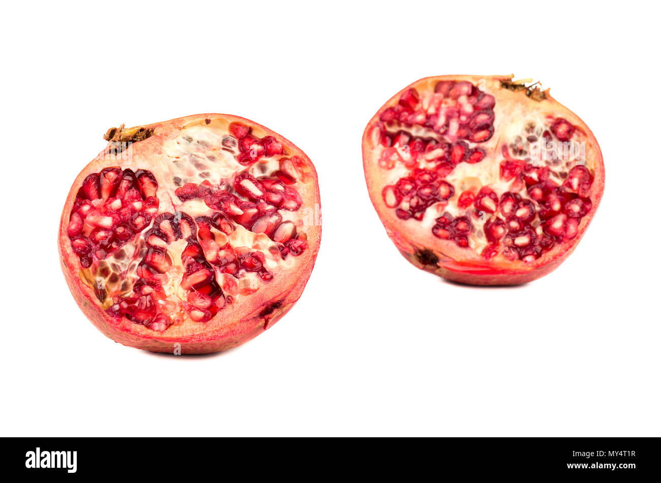 Two halves of juicy pomegranate isolated on white background Stock Photo