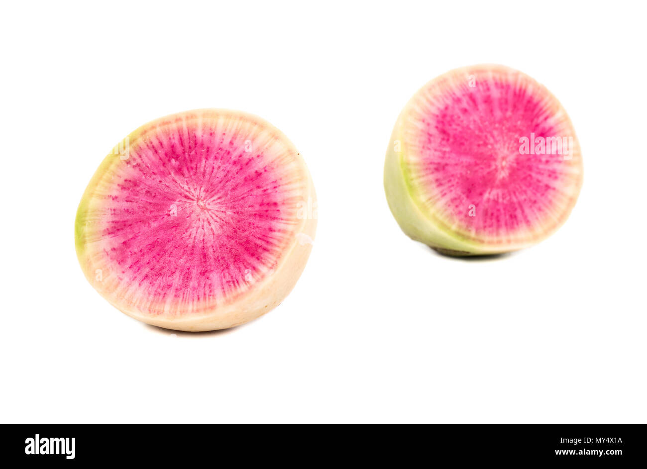 Two halves of watermelon radishes on a white background Stock Photo