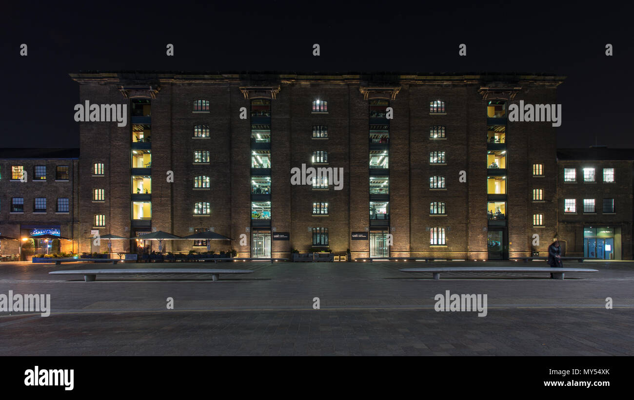 London, England, UK - February 22, 2018: Central St Martin's College, part of the University of the Arts, is lit up at night in Granary Square, part Stock Photo