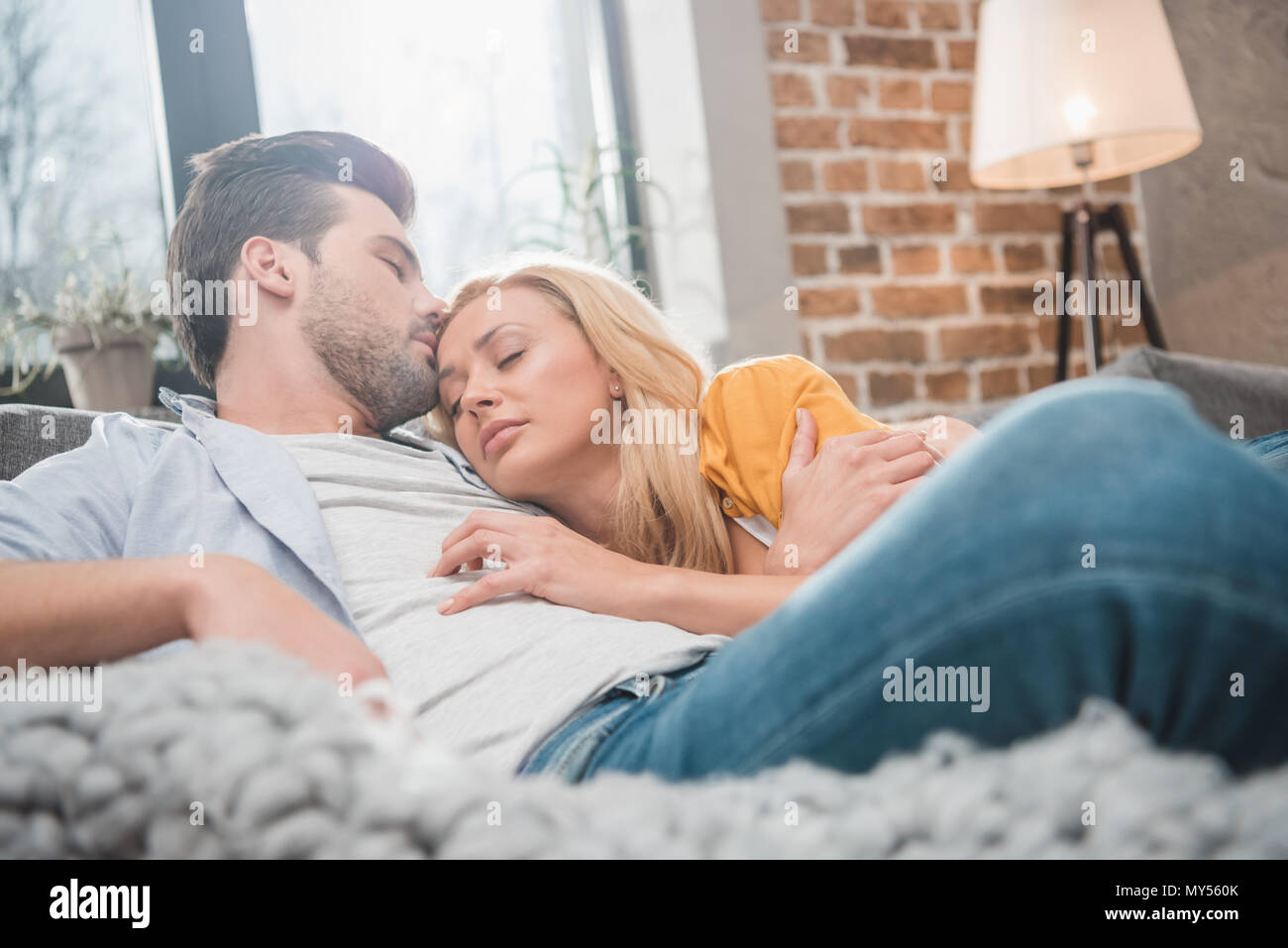 Young couple sleep on couch hires stock photography and images Alamy