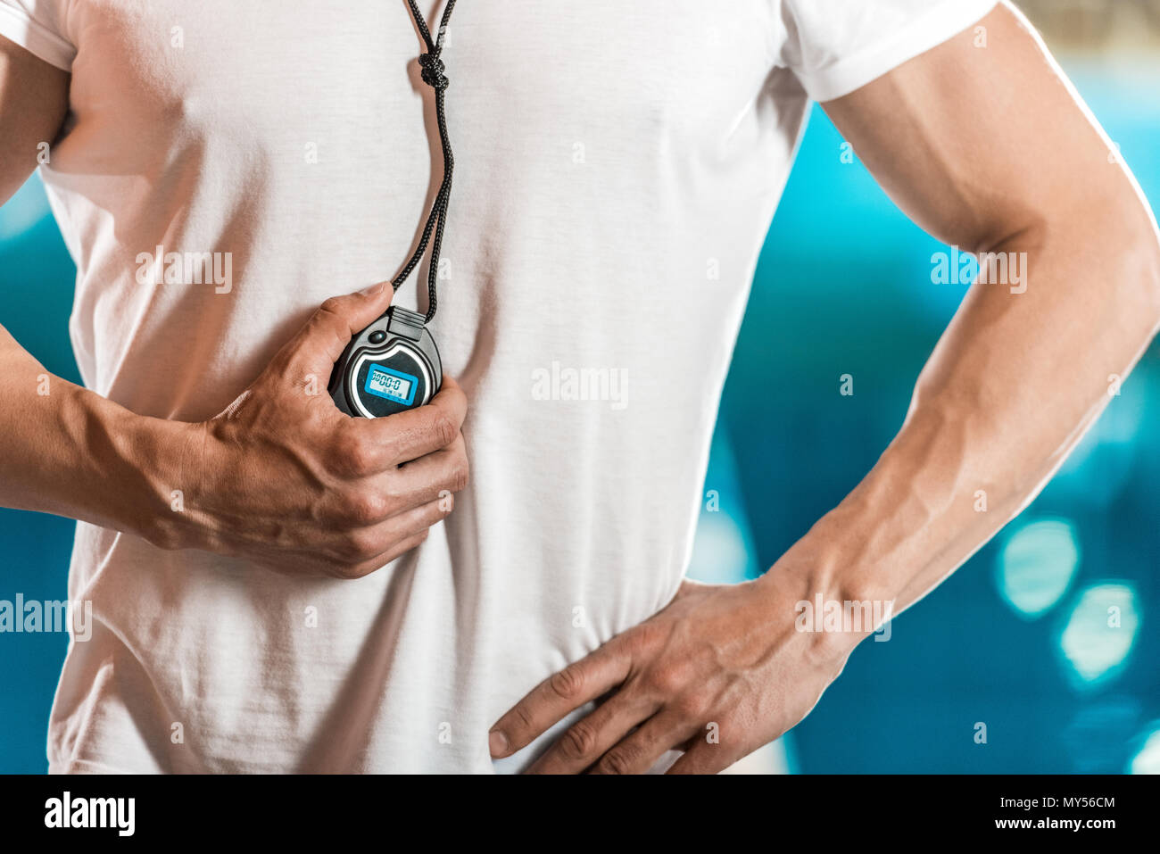 cropped view of swim trainer with stopwatch at swimming pool Stock ...