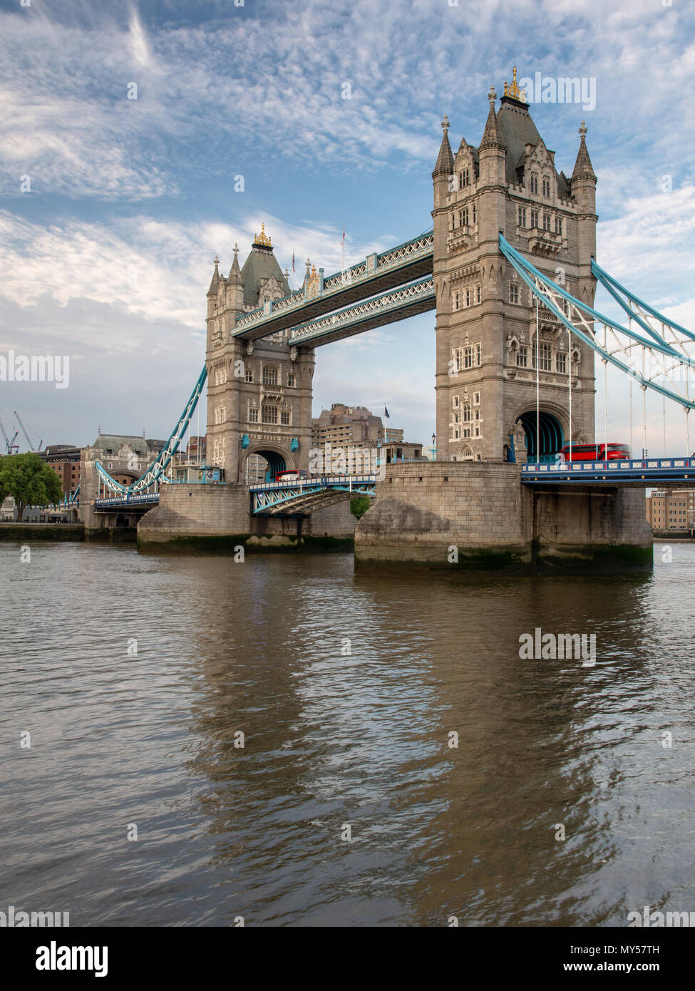 London, England, UK - June 1, 2018: A traditional red double-decker bus crosses London's Tower Bridge. Stock Photo
